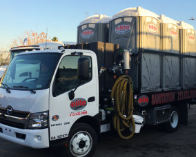 diagonal view of truck loaded with portable toilets