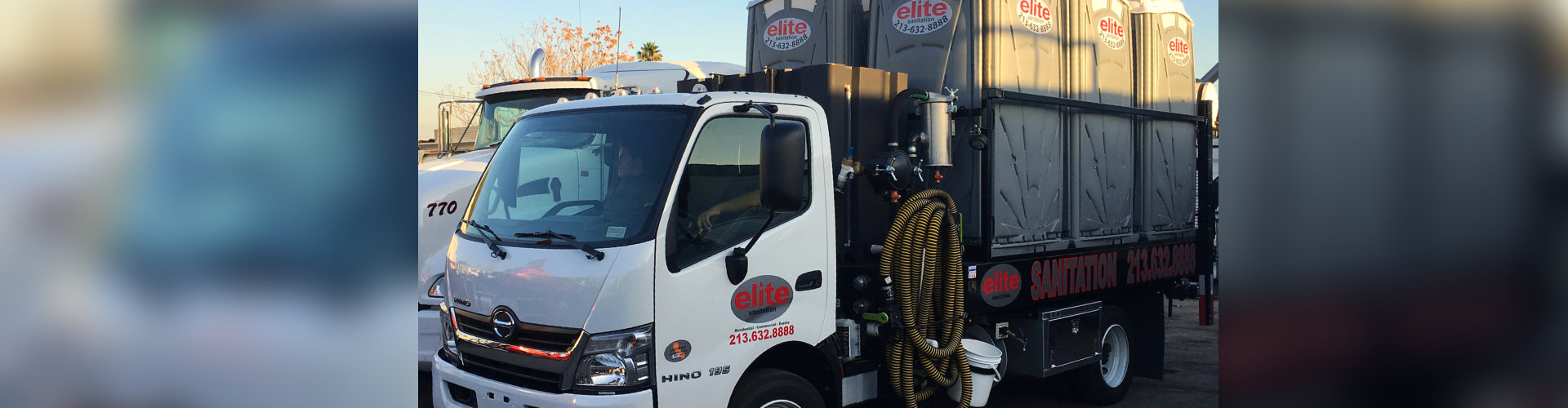 truck transporting portable toilets